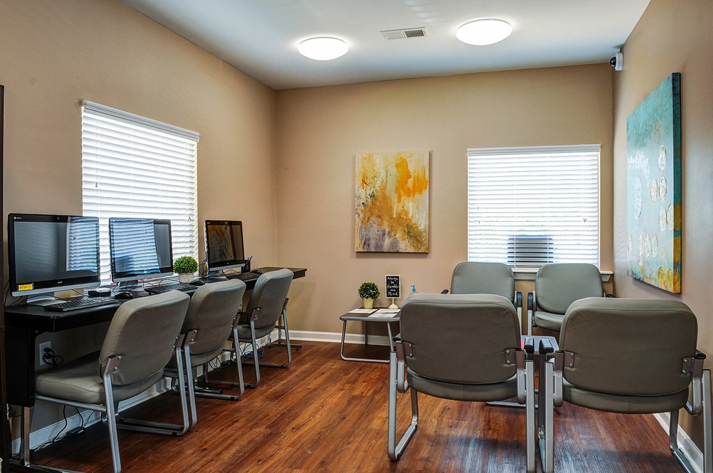 a conference room with desks and chairs and computers