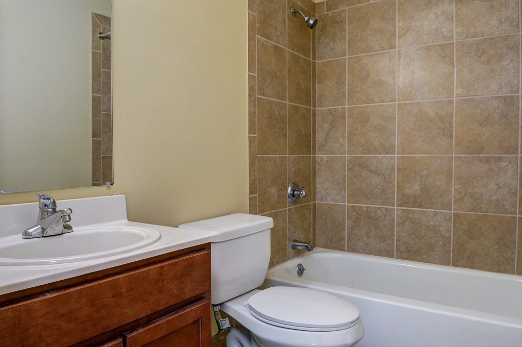 a bathroom with a sink toilet and a tub