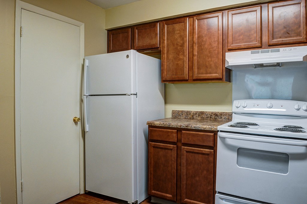 a kitchen with a stove refrigerator and cabinets