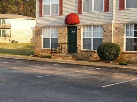 A building with a red awning and a green door.
