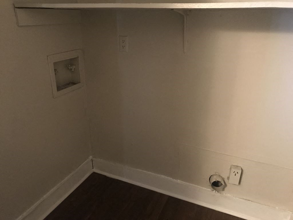 A small square window in a white wall.