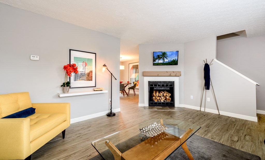 a living room with a fireplace and a table