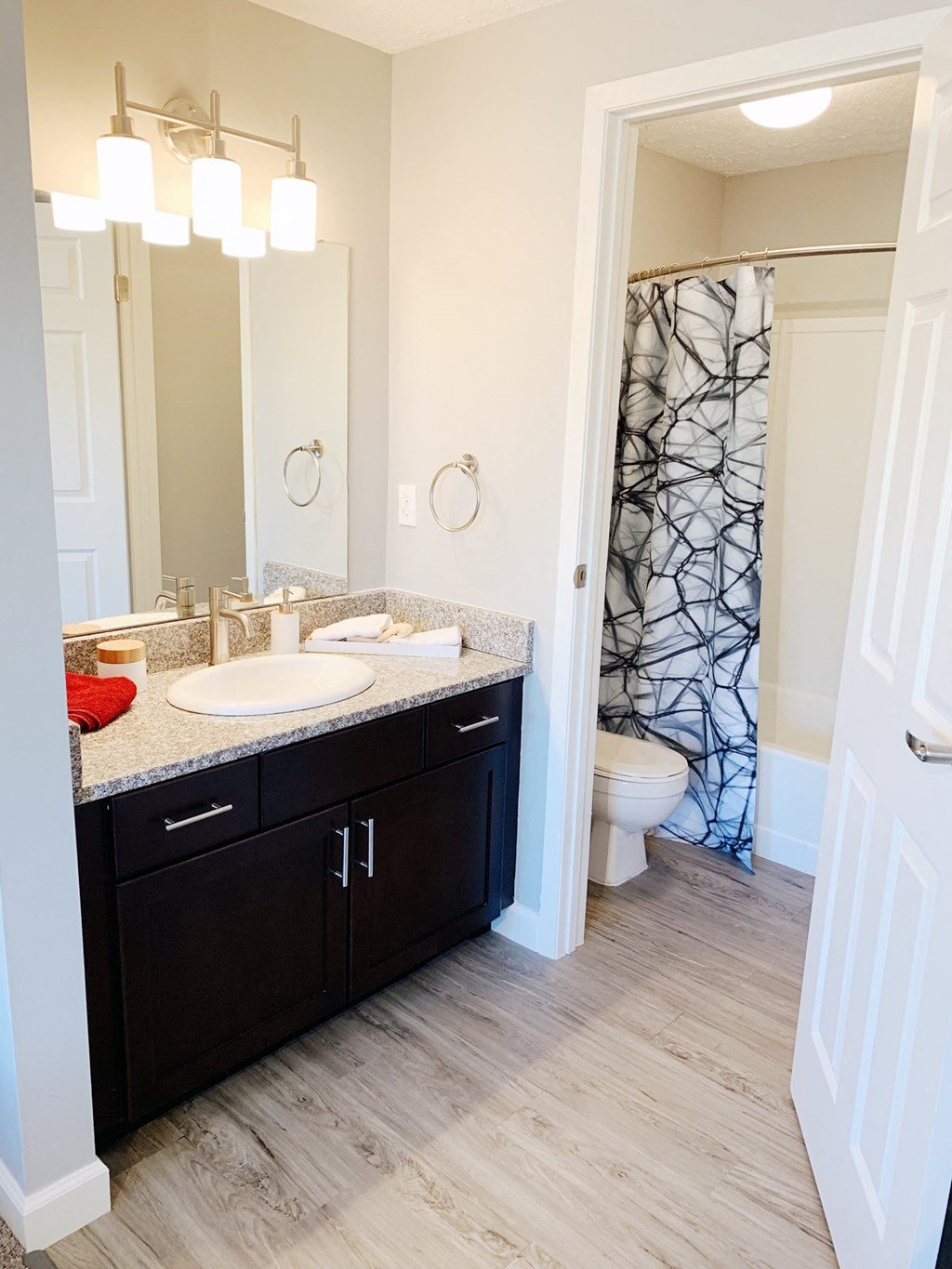 a bathroom with a sink and a shower and a toilet