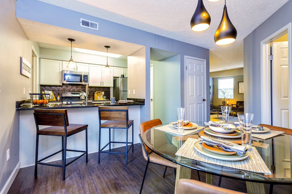 a dining room and kitchen with a table and chairs