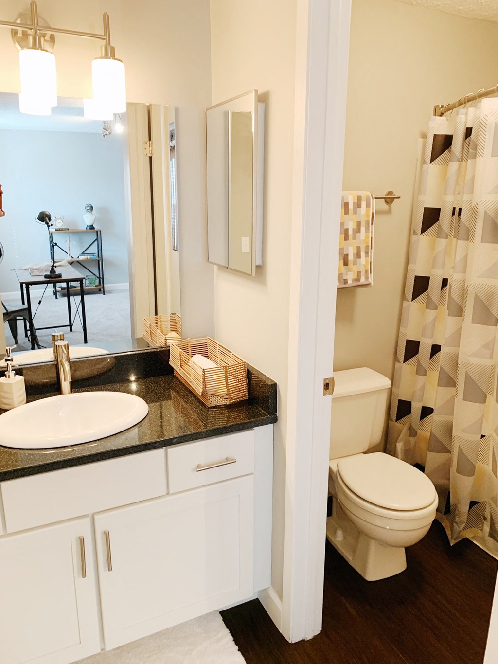 a bathroom with a toilet and a sink and a shower