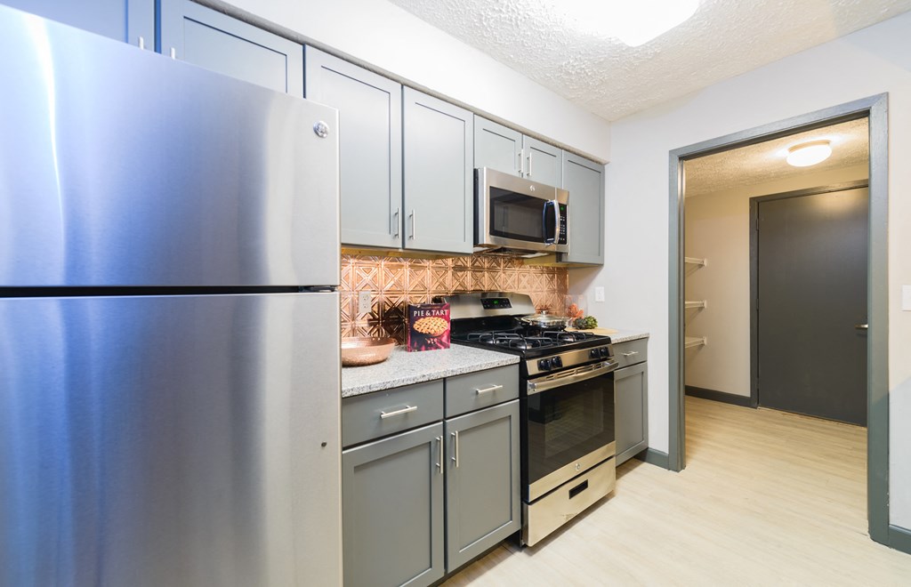 a kitchen with stainless steel appliances and a stainless steel refrigerator