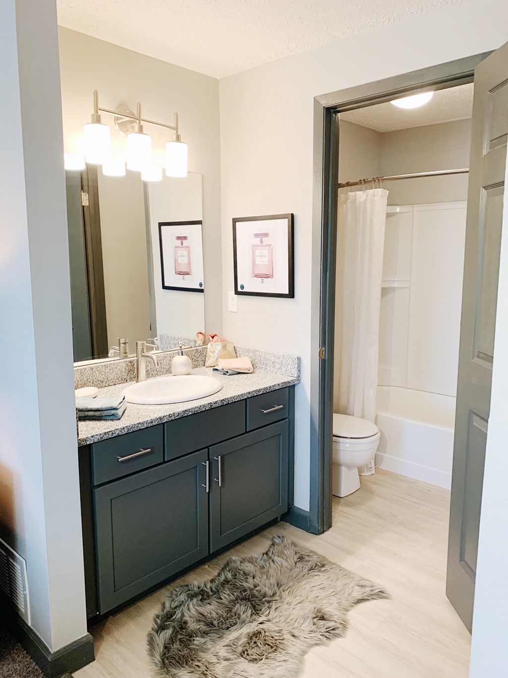 a bathroom with a mirror and a sink and a toilet