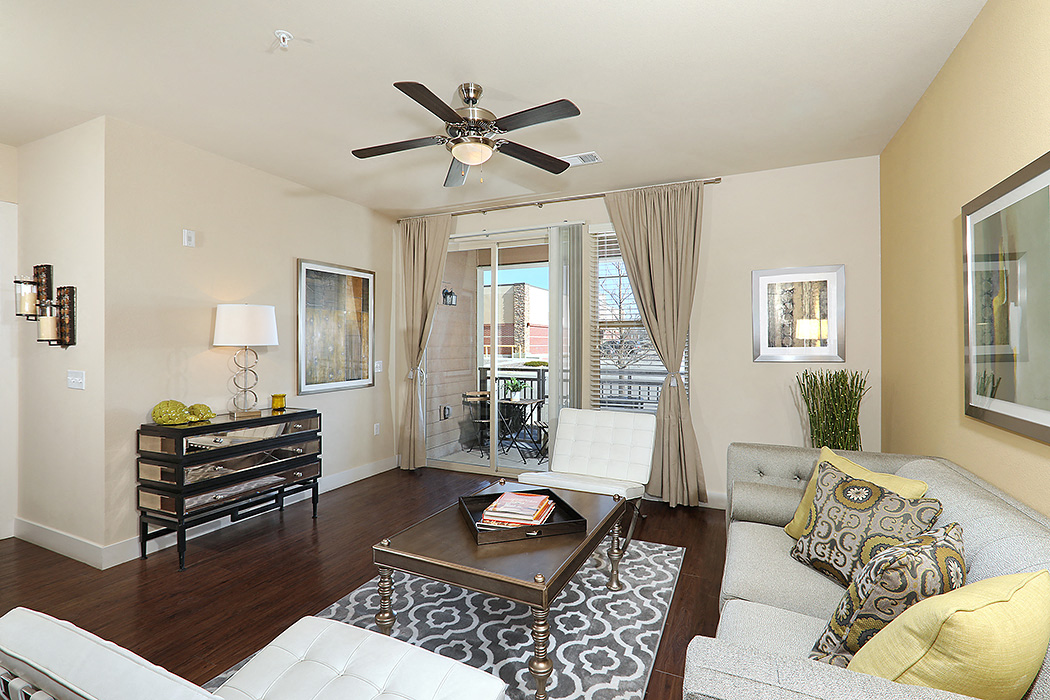 a living room with a couch and a ceiling fan