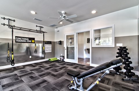 fitness center with equipment at Aventura at Towne Centre, Missouri