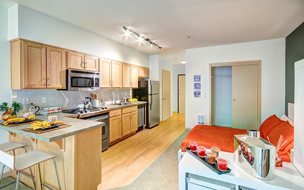 a kitchen with wooden cabinets and stainless steel appliances and a counter top