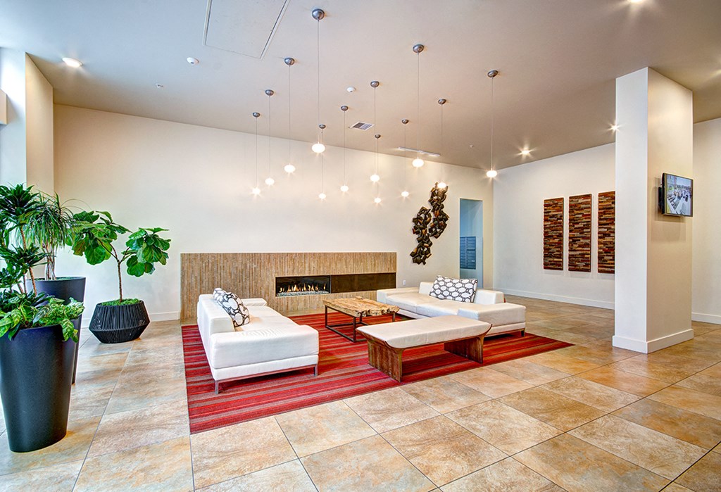 a living room with couches and chairs and a fireplace