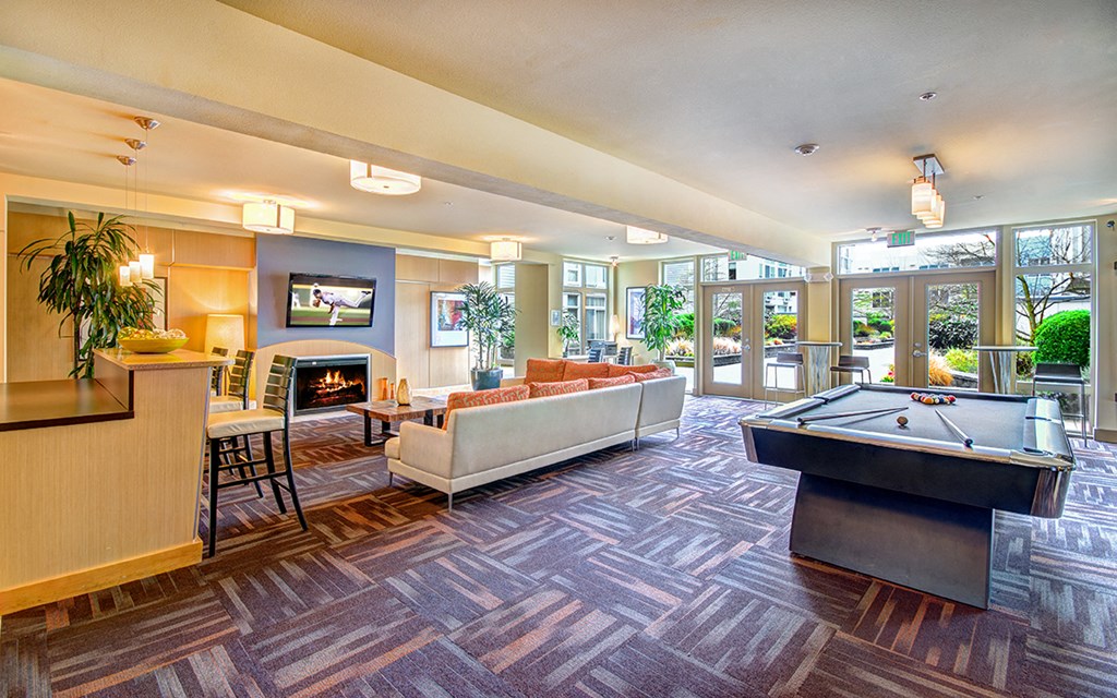 a game room with a pool table and a tv