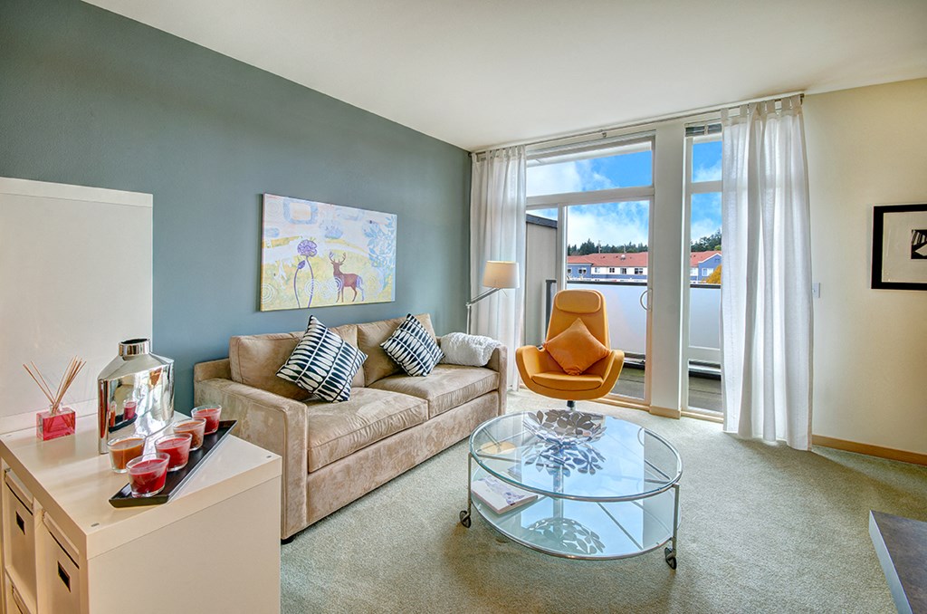 a living room with a couch and a glass coffee table
