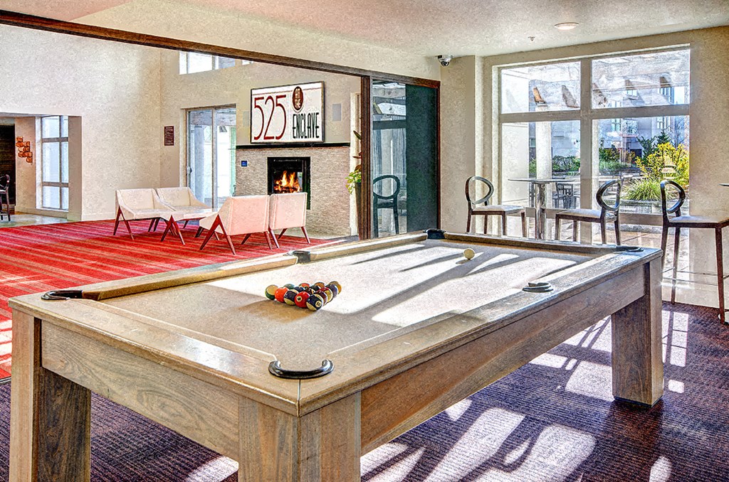 a games room with a pool table and a fireplace