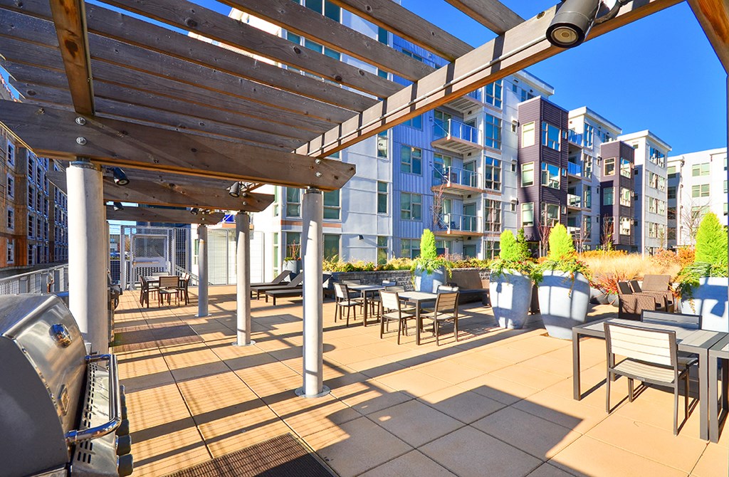 a patio with tables and chairs and a pergola