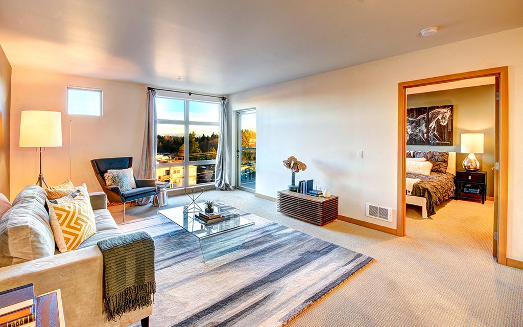 a living room with a couch and a table and a large window