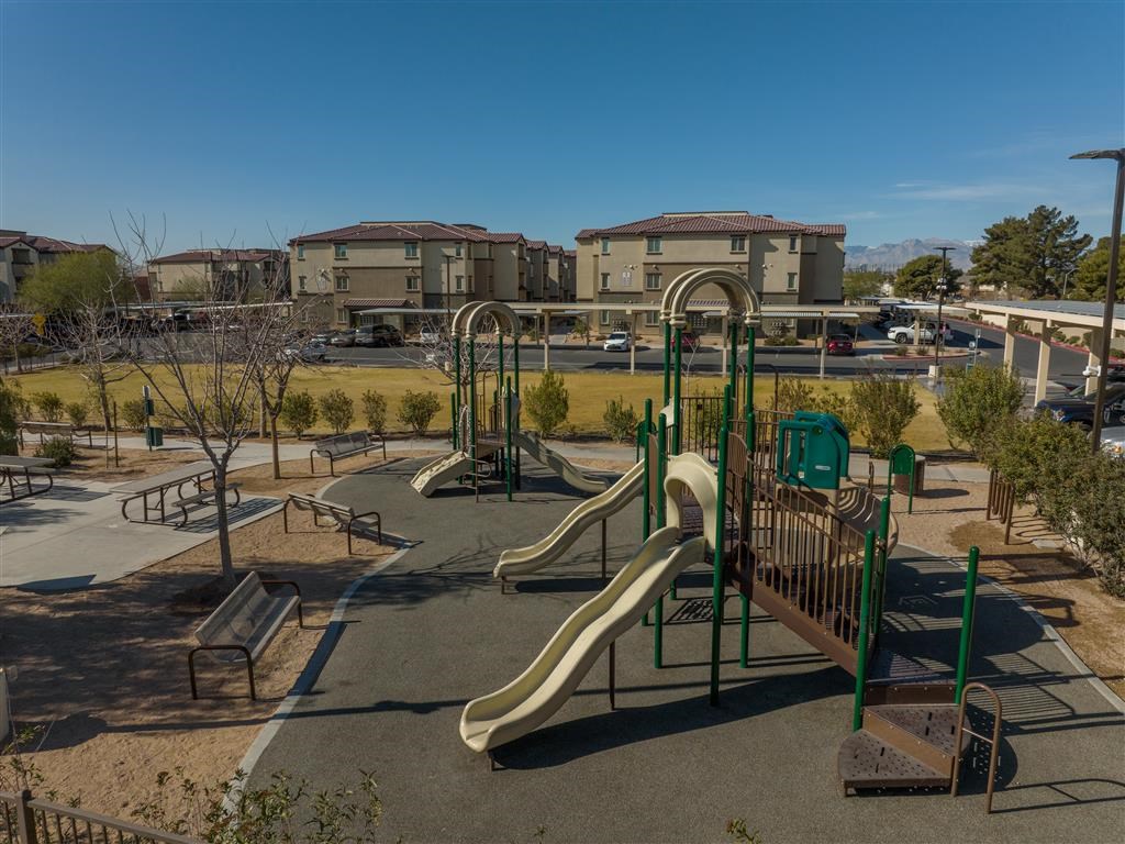 a playground with slides and other equipment in a park
