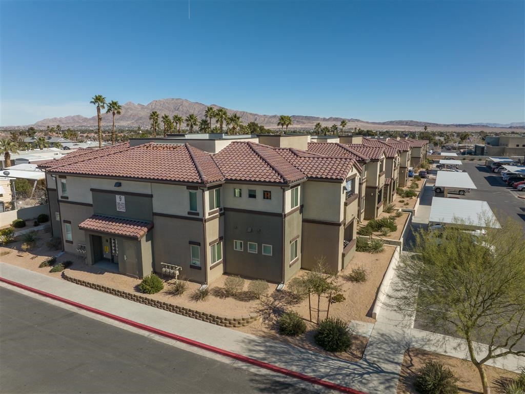 an aerial view of a row of houses in a parking lot