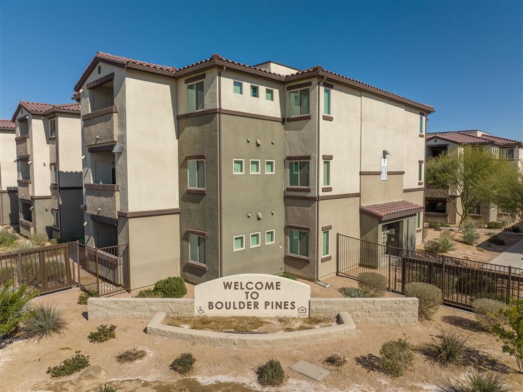 a building with a sign that reads welcome to boulder pines