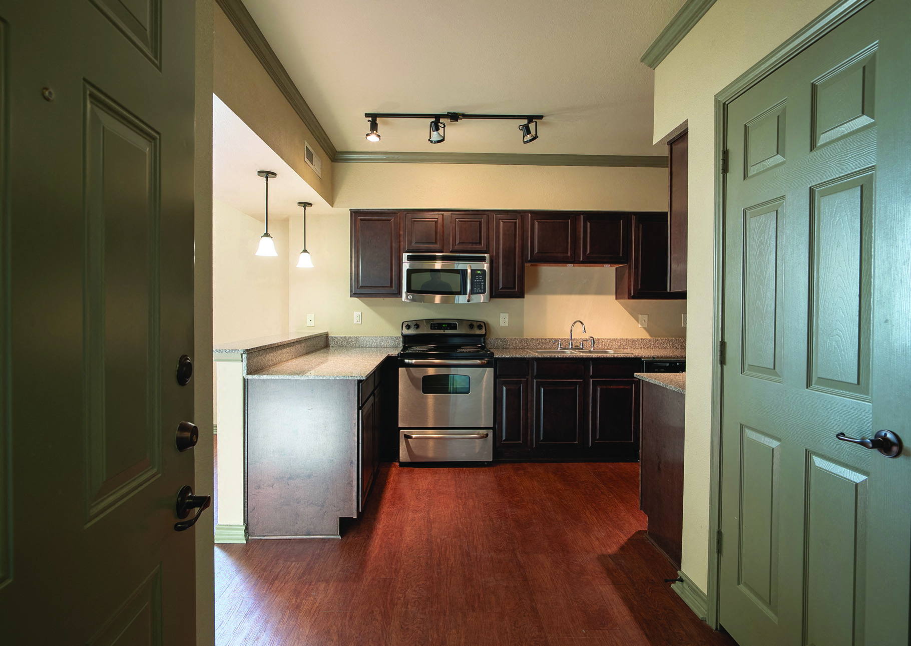 a kitchen with stainless steel appliances and wooden cabinets