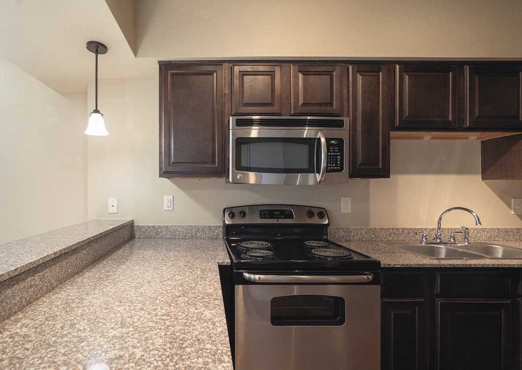 a kitchen with stainless steel appliances and a granite counter top