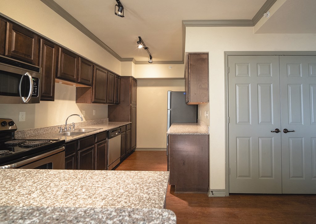 an empty kitchen with a blue door