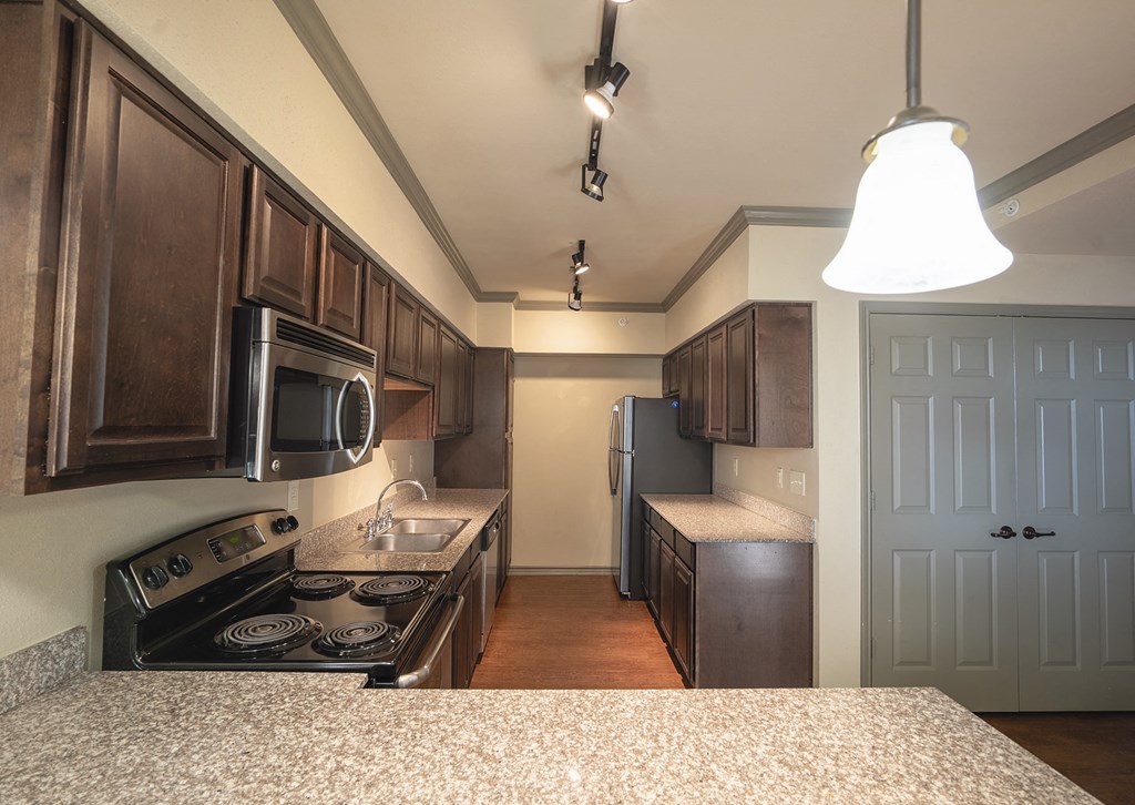 a kitchen with a stove and a sink and a refrigerator
