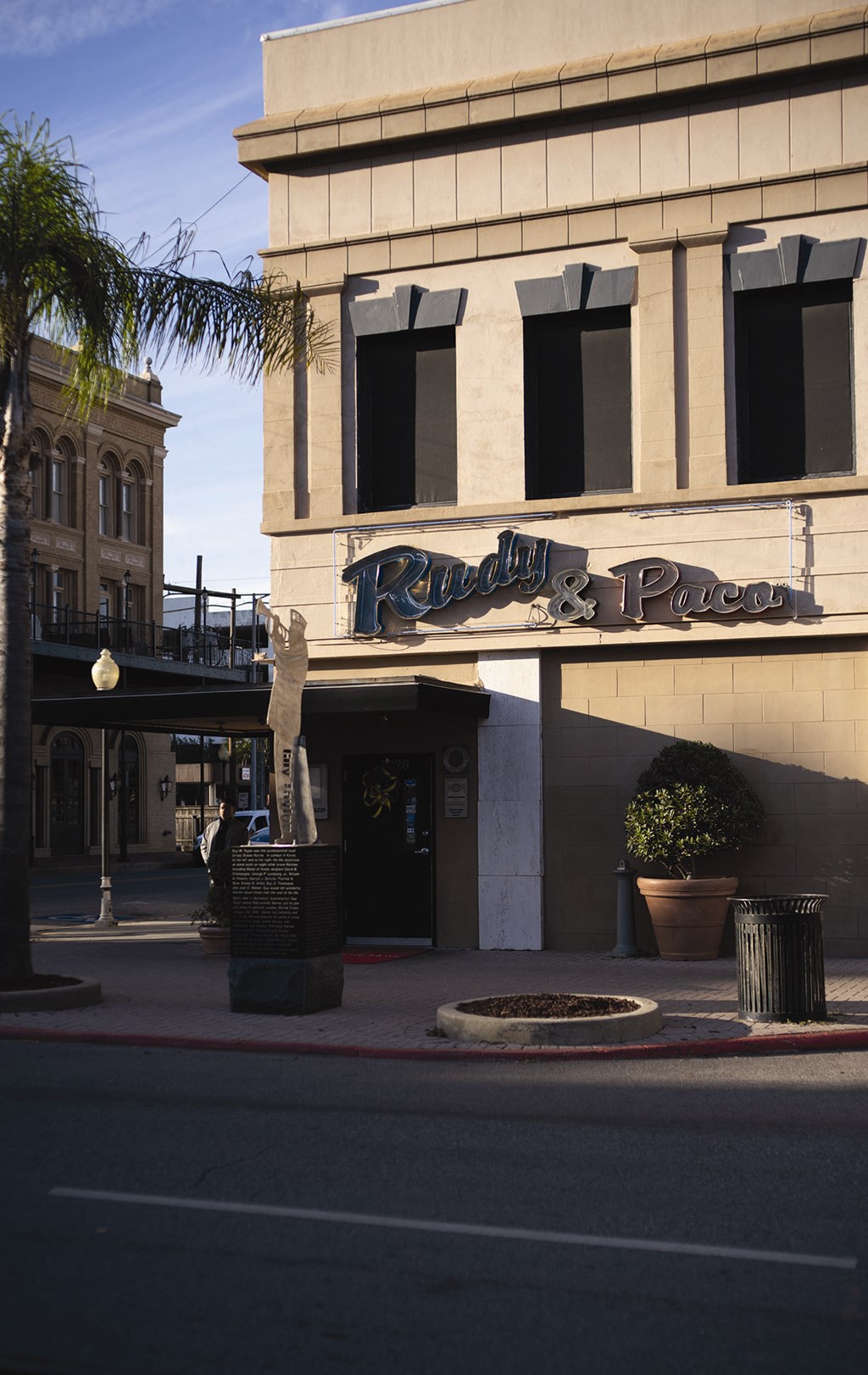 a building with a sign on it on the side of a street
