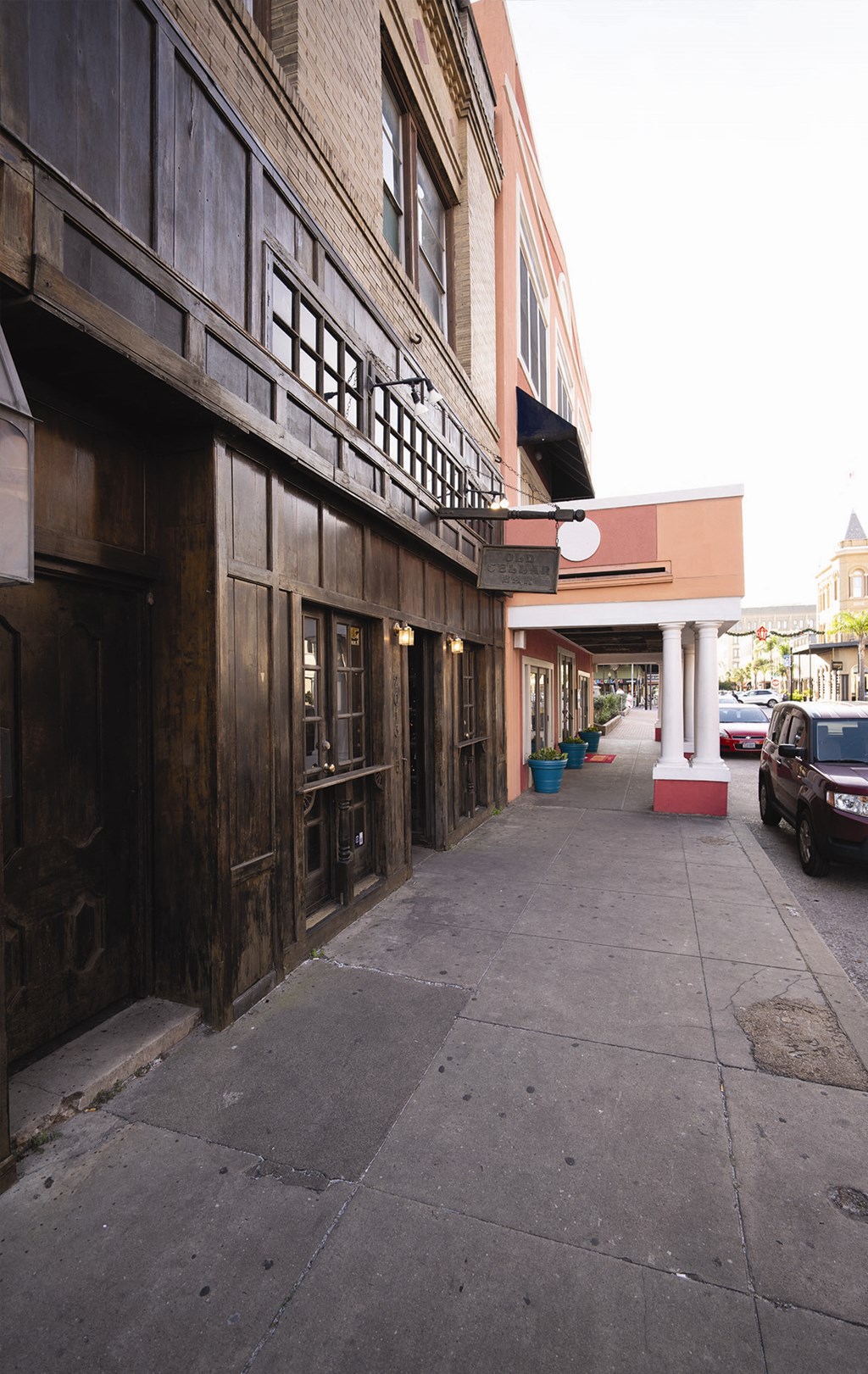a city street with a building and a car parked