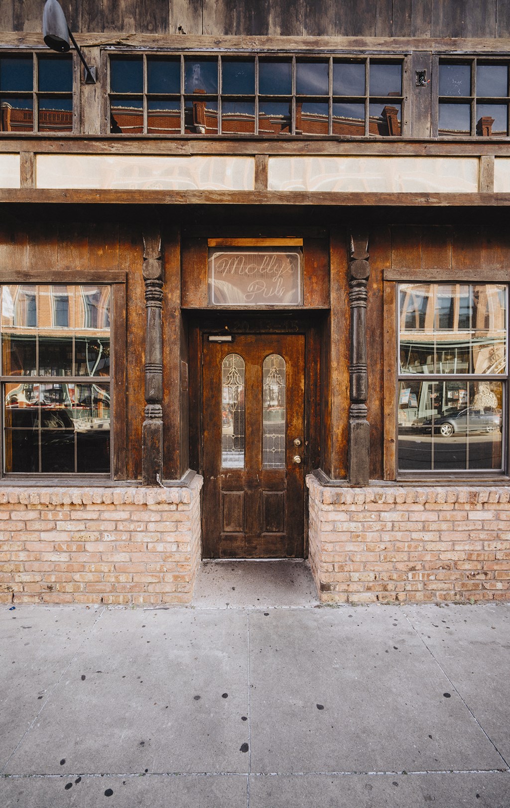 the front of a brick building with a wooden door