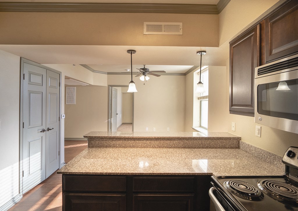 a kitchen with a granite counter top and a stove