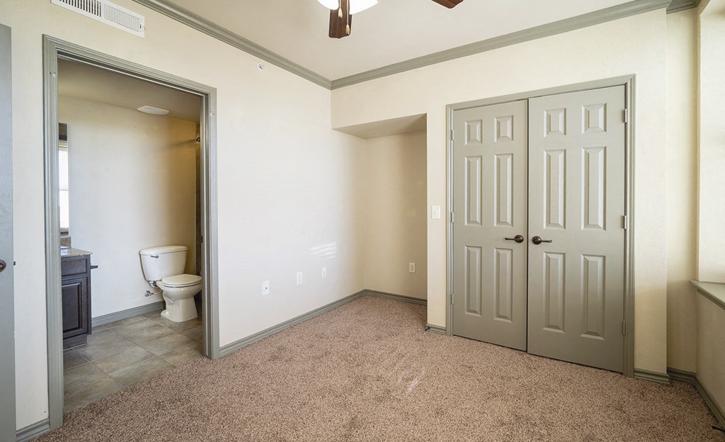 a empty room with a toilet and a closet