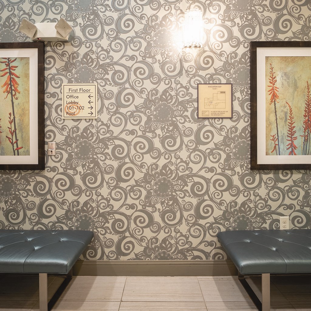 a room with benches and pictures on the wall