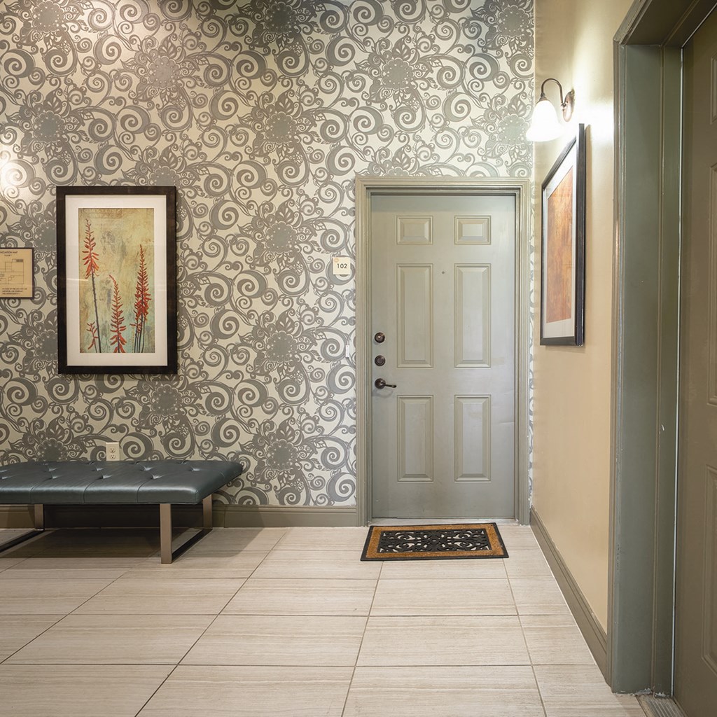 a hallway with a door and a painting on the wall