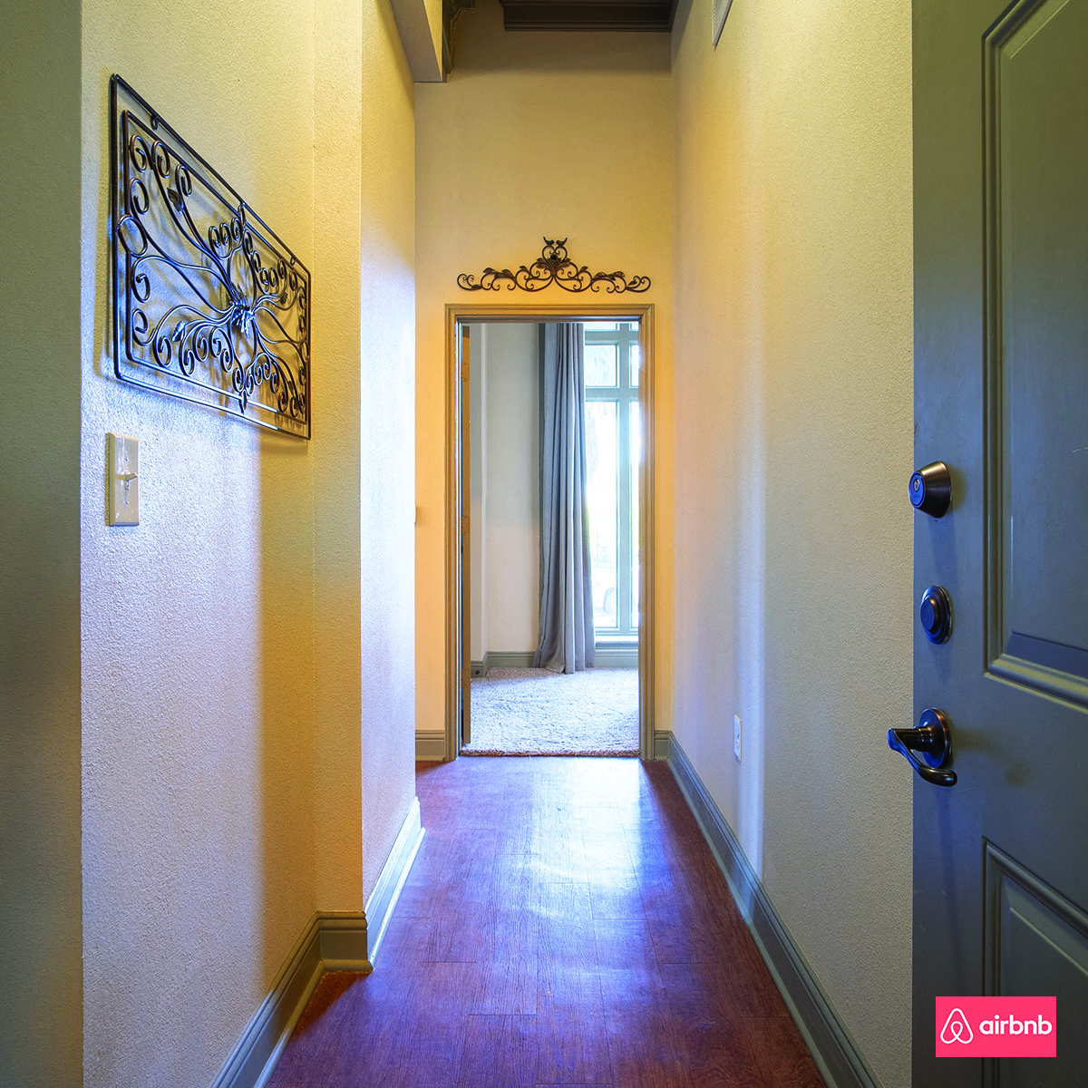 a hallway with a door and a mirror on the wall