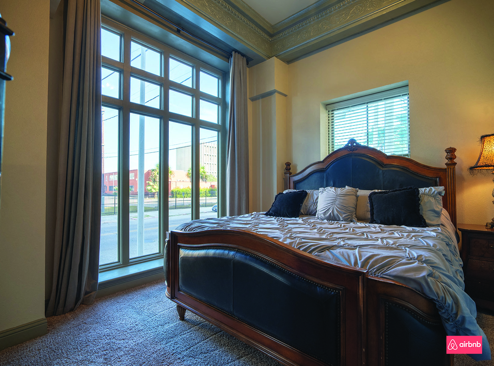 a bedroom with a large bed and a window