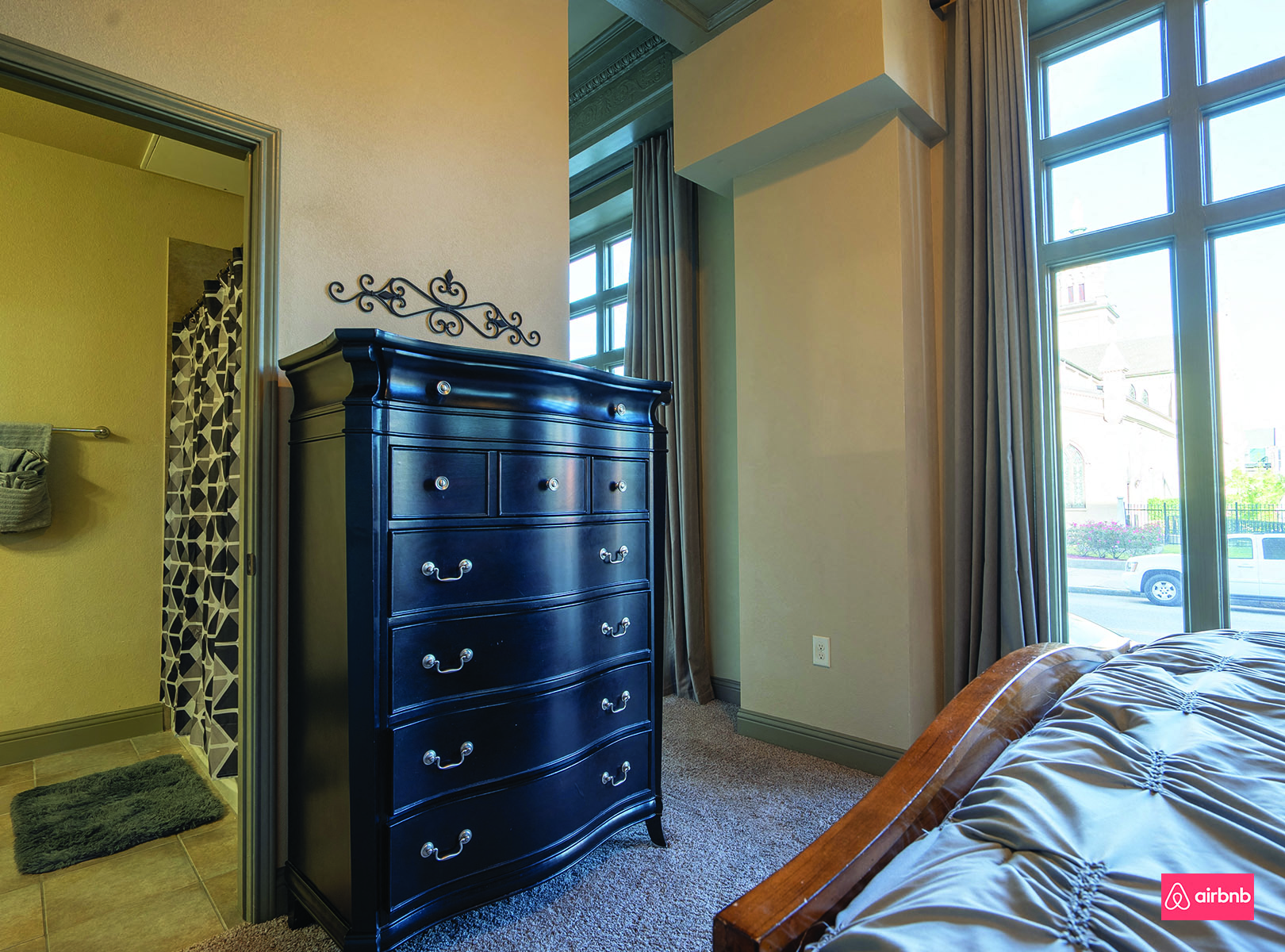 a bedroom with a dresser and a window