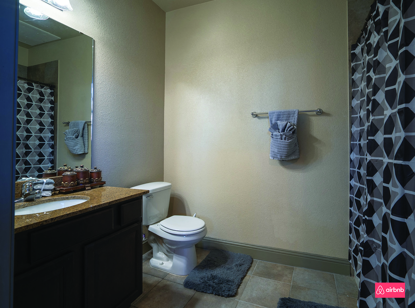 a bathroom with a toilet and a shower and a sink