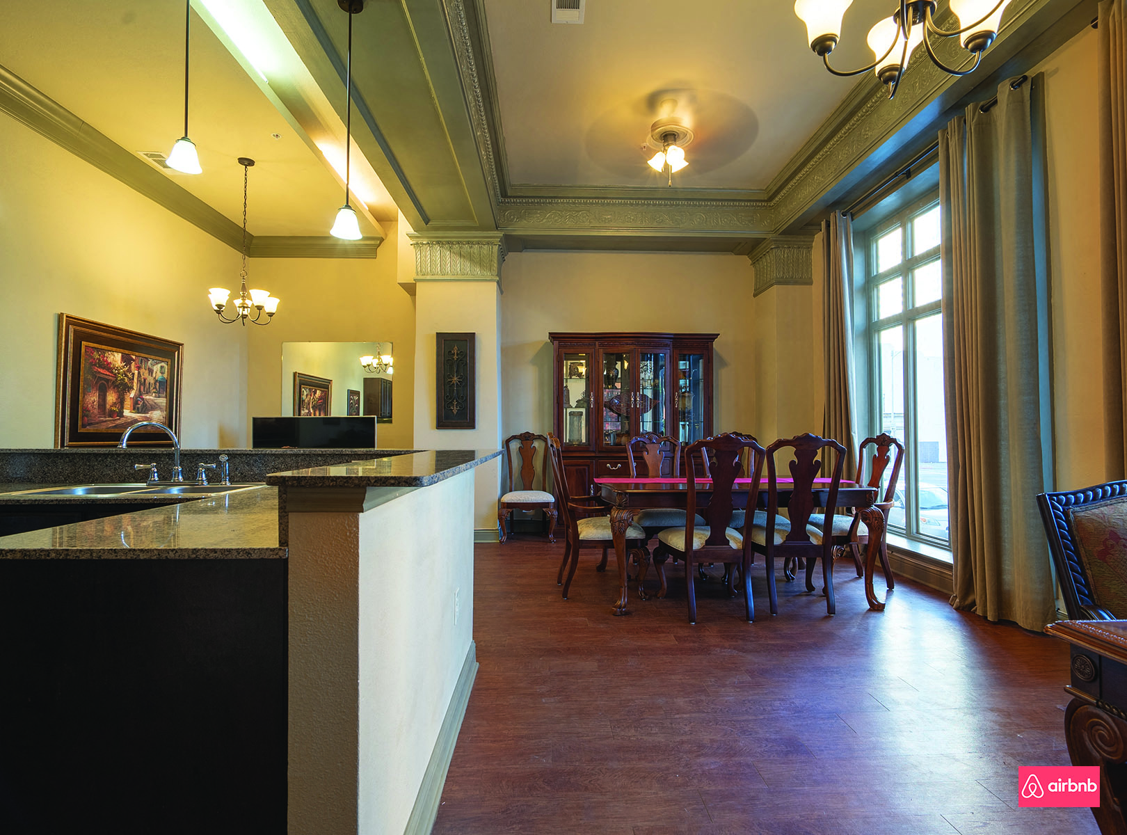 a dining room and kitchen with a table and chairs