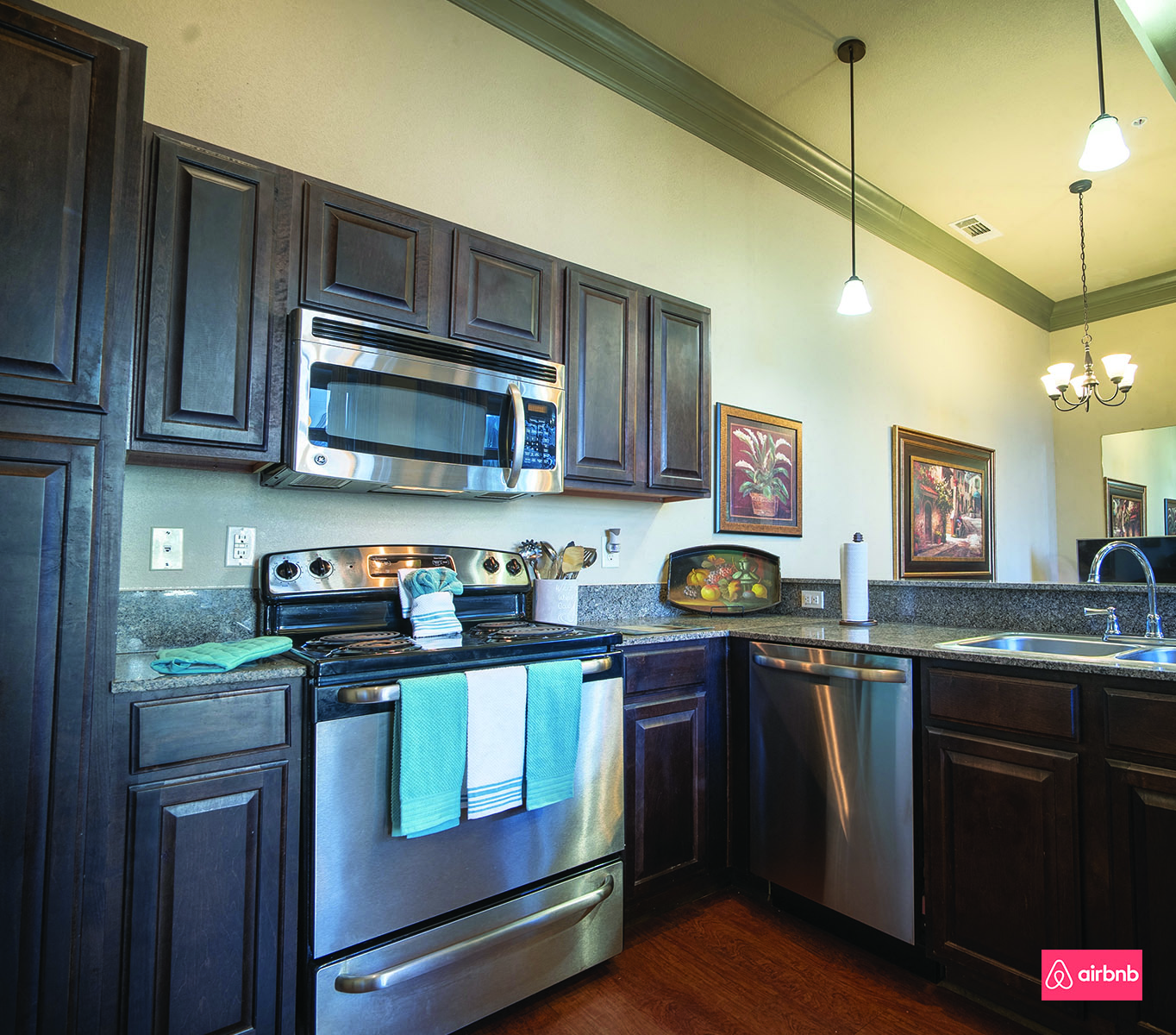 a kitchen with stainless steel appliances and black cabinets