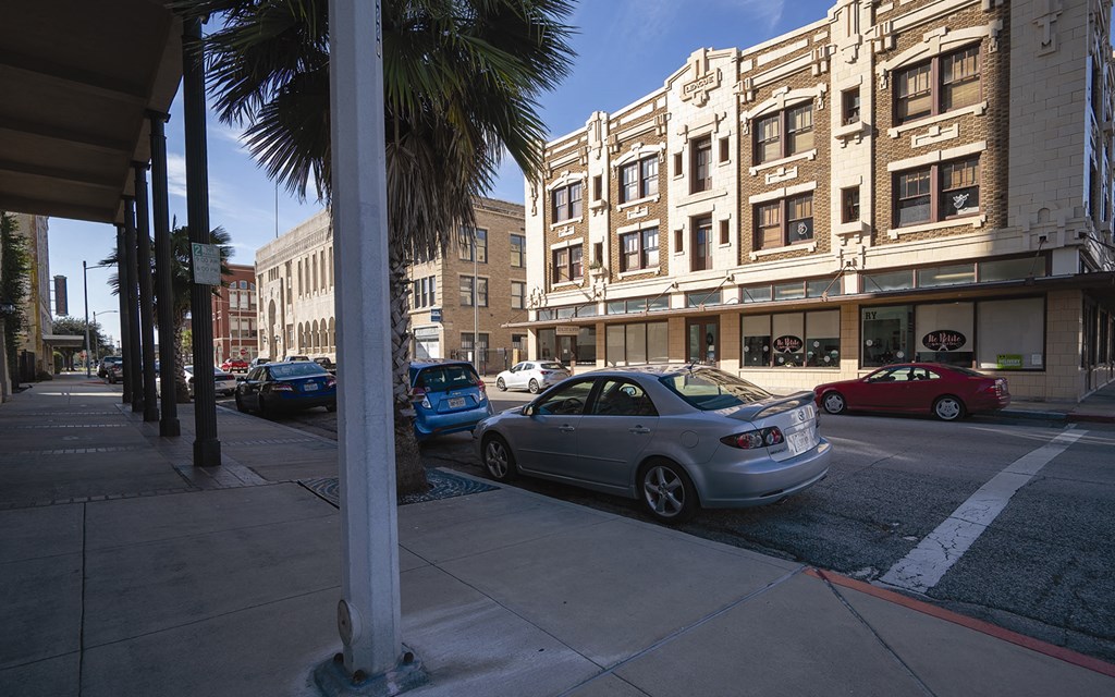 a city street with cars parked in front of buildings
