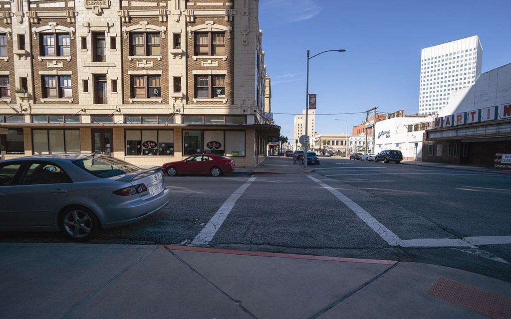 a city street with cars parked on the side of it