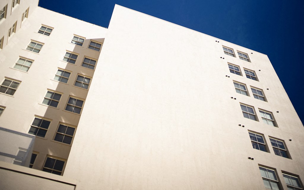 a tall white building against a blue sky