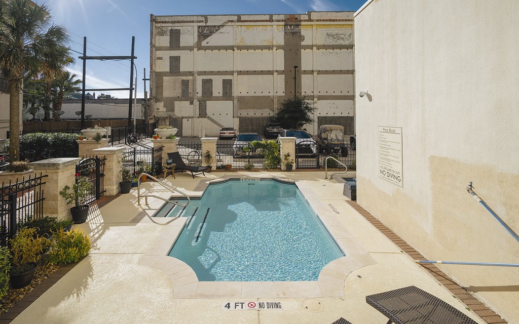 a swimming pool with a building in the background