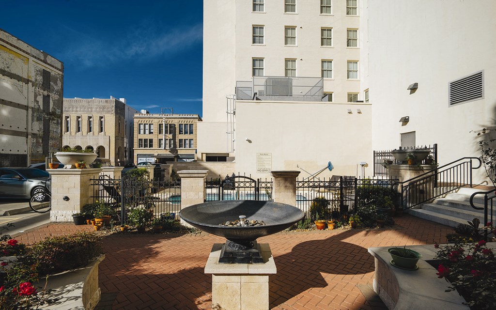 a fountain in a courtyard in front of a building