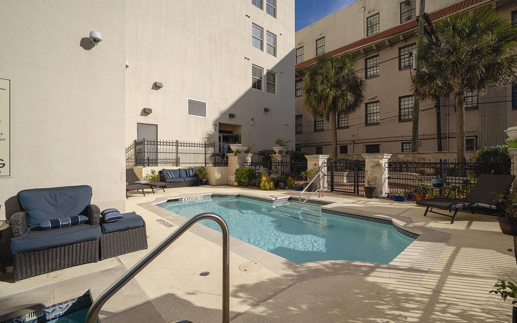 the pool at our apartments is surrounded by palm trees