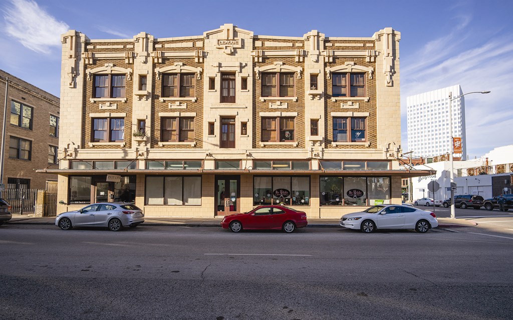 an old building on a city street with cars