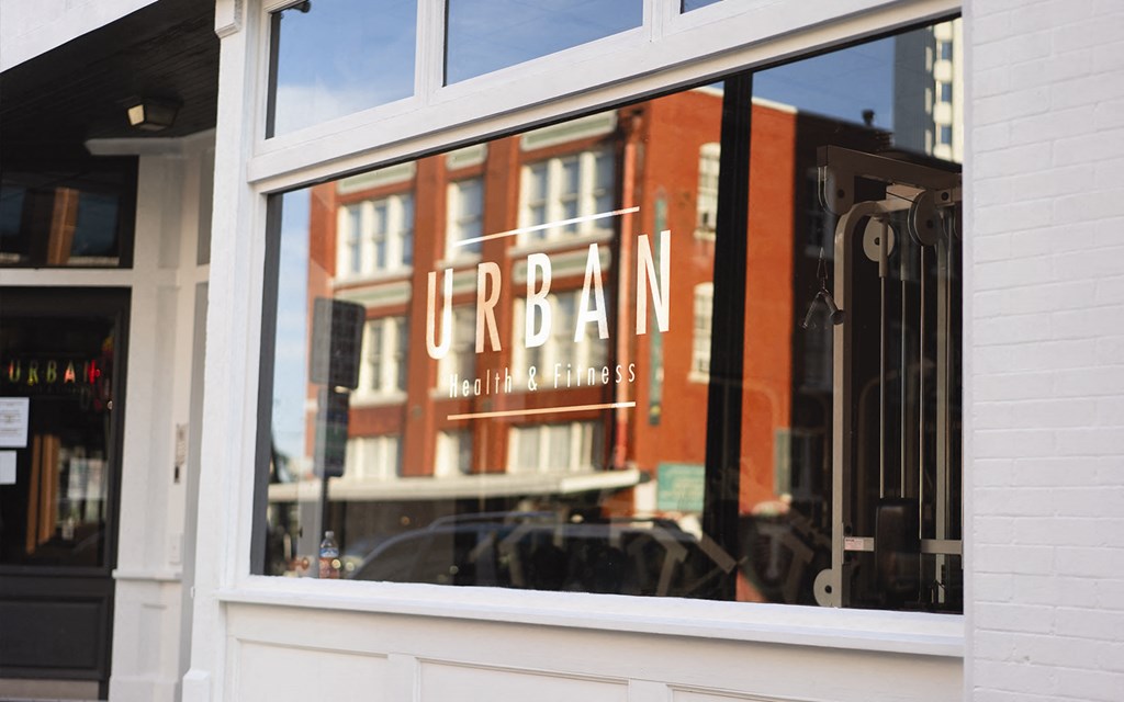 the reflection of a red building in the window of a restaurant