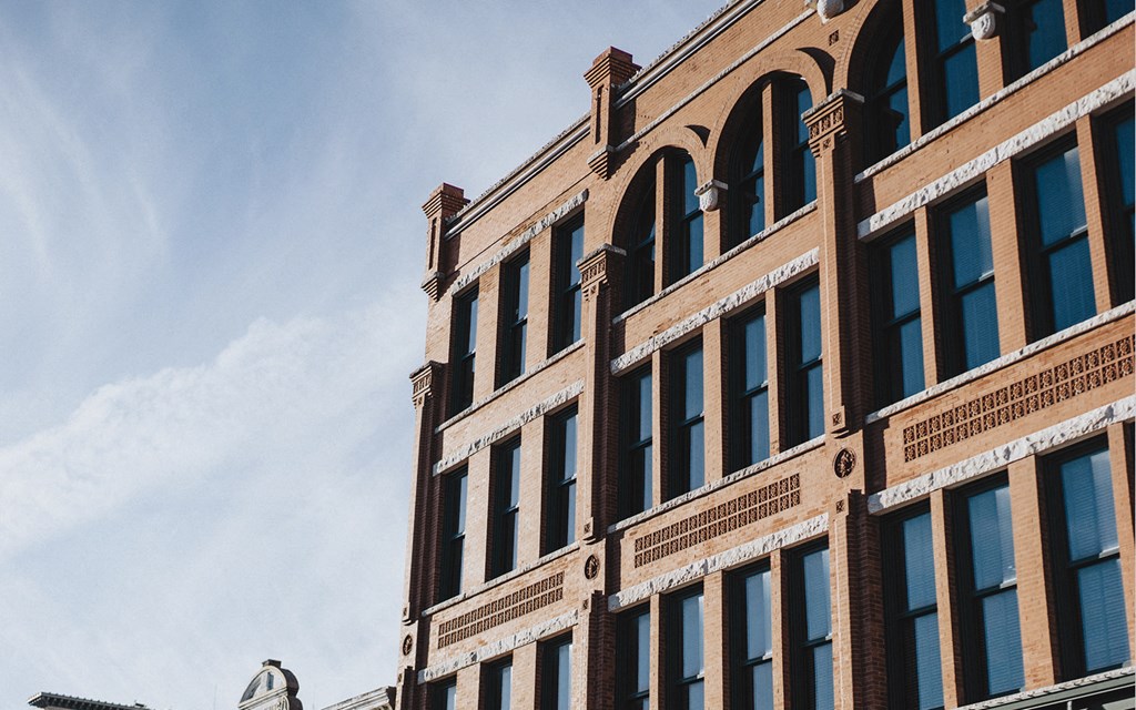 a red brick building with a blue sky in the background