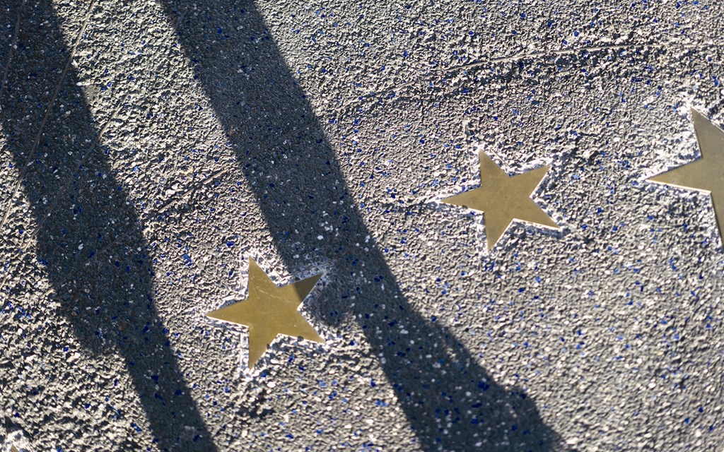 three yellow stars on the floor with a blue line